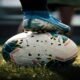 white and blue soccer ball on green grass field